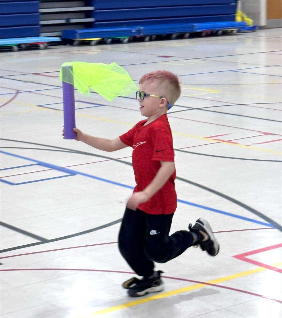 A student doing a torch relay race in PE class. 
