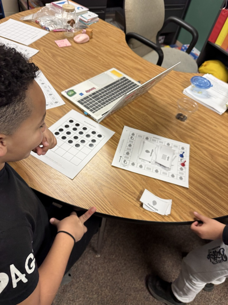 two students playing a science board game 