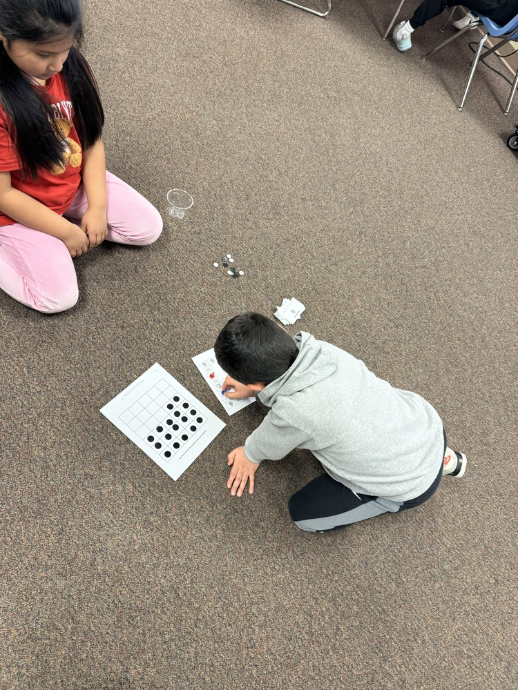 two students playing a science board game 
