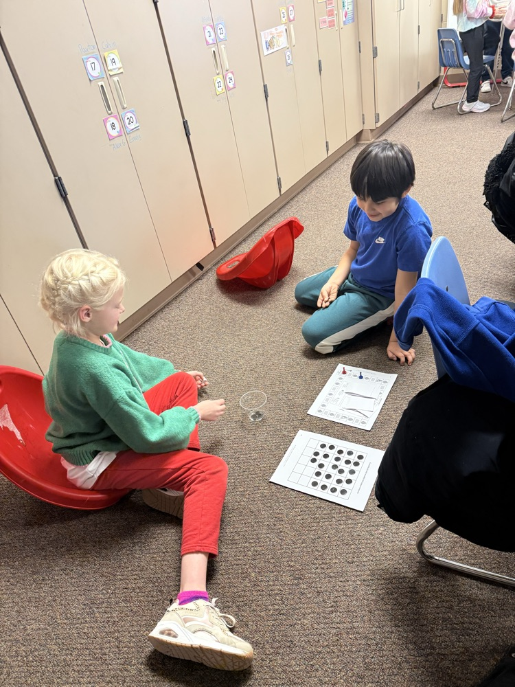 two students playing a science board game 