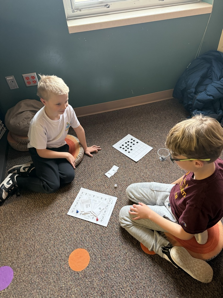two students playing a science board game 