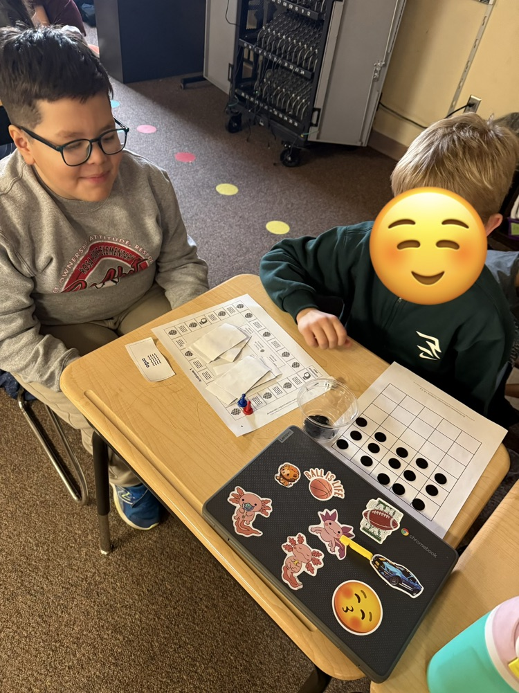 two students playing a science board game 