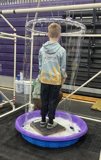 Student at Water Festival in a bubble.