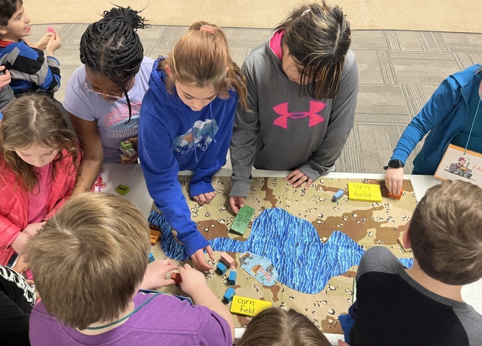 Students at Water Festival charting a map. 