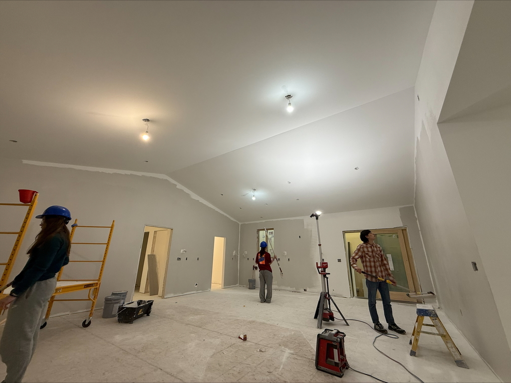 Students painting the walls in the CTE house