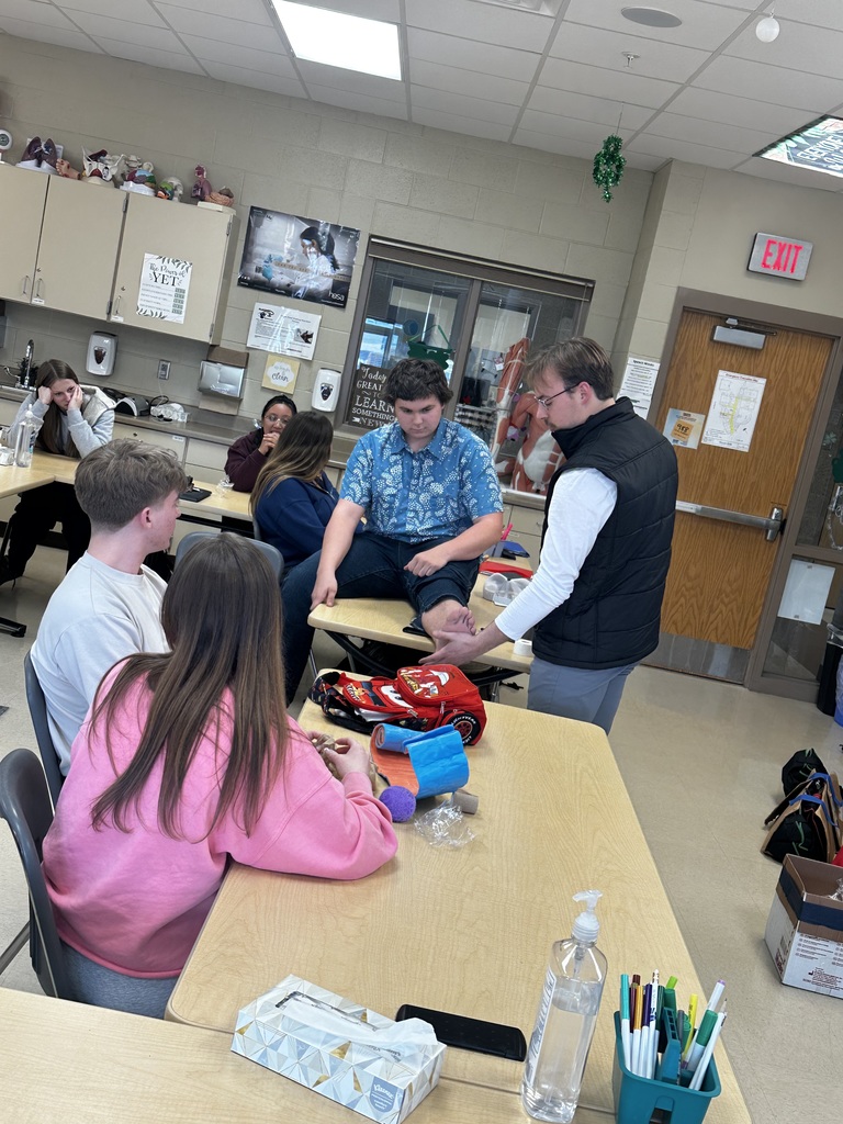 Athletic trainer demonstrating out to tape a foot