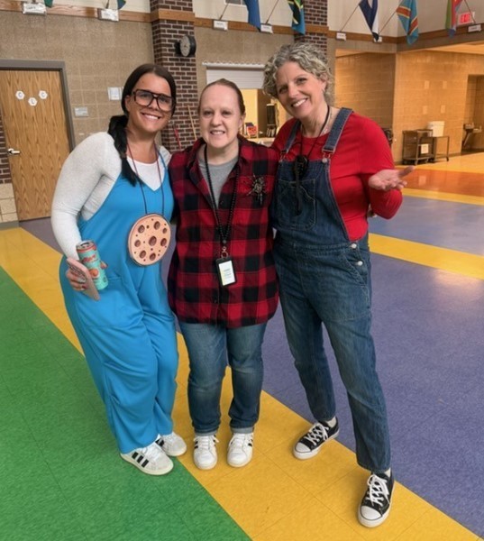 Three teachers dressed up as book characters.