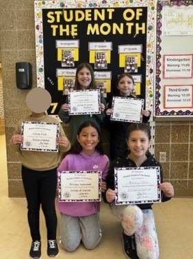 4th grade students holding student of the month certificates