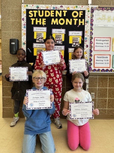 3rd grade students holding student of the month certificates