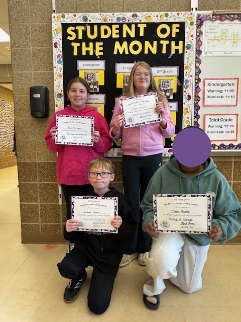 5th grade students holding student of the month certificates