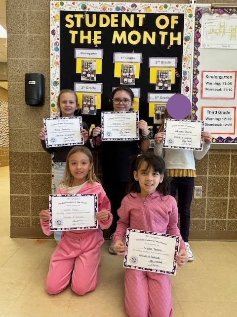 2nd grade students holding student of the month certificates