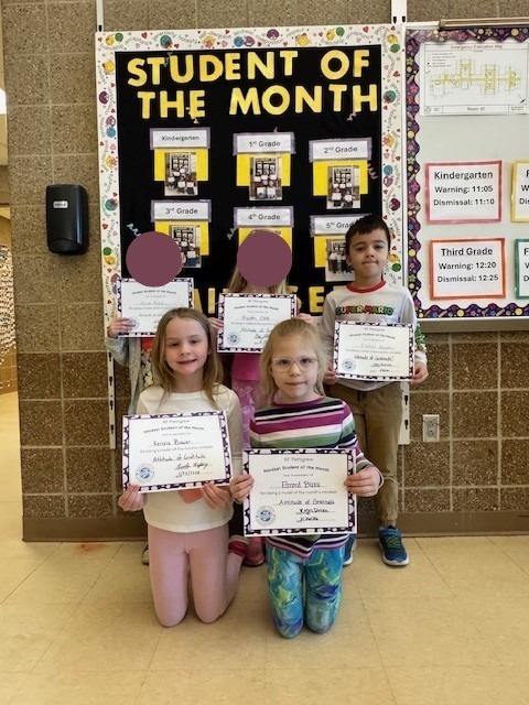 1st grade students holding student of the month certificates