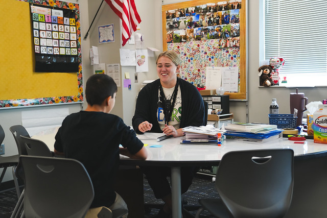 Fourth grade teacher working with a student.