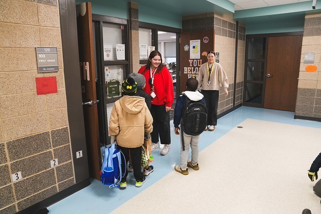 First grade teachers welcoming students.