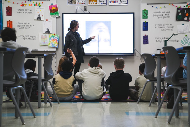 Art teacher teaching at the board.