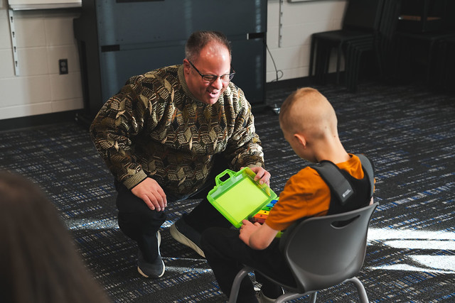 Music teacher working with a student.