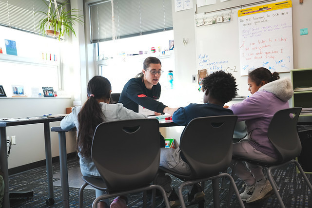 Third grade teacher working with students.