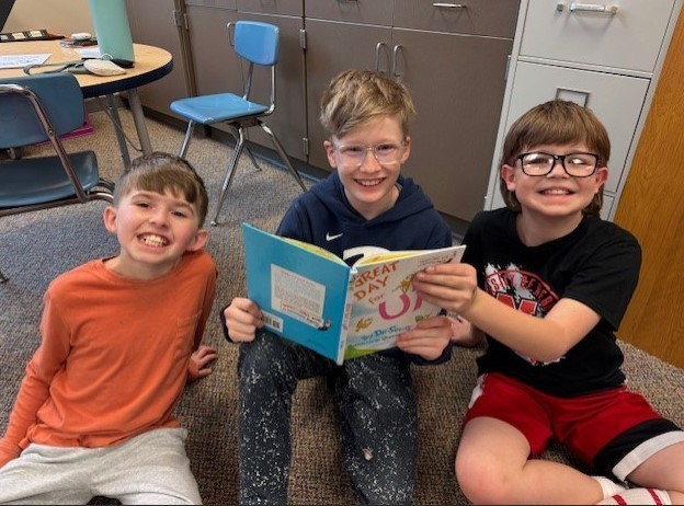 303 Students paired up reading Dr. Seuss.