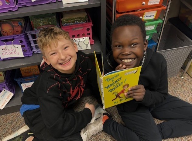 303 Students paired up reading Dr. Seuss.