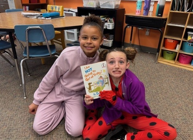 303 Students paired up reading Dr. Seuss.