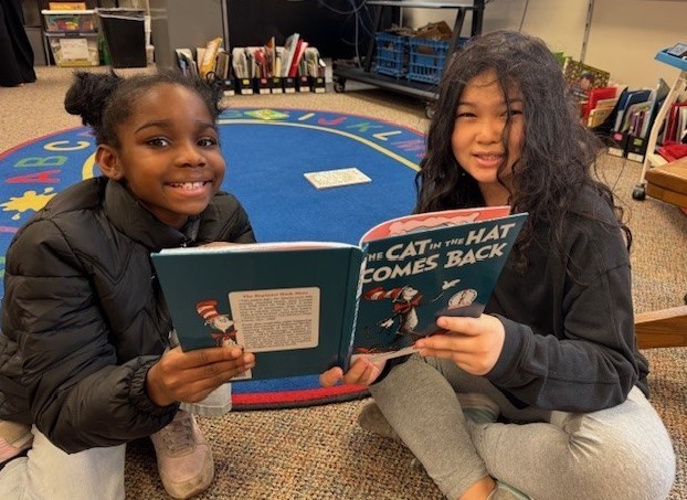 303 Students paired up reading Dr. Seuss.