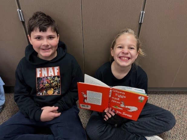 303 Students paired up reading Dr. Seuss.