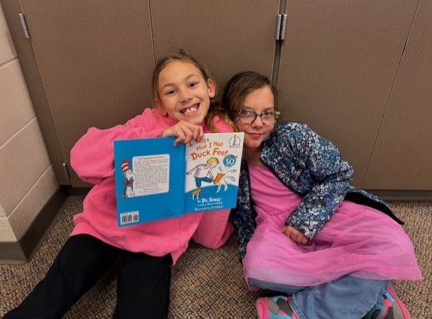 303 Students paired up reading Dr. Seuss.