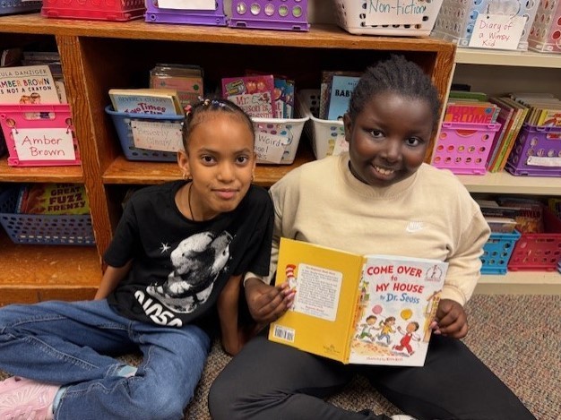 303 Students paired up reading Dr. Seuss.