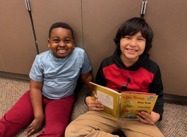 303 Students paired up reading Dr. Seuss.