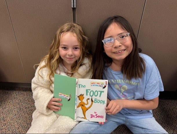 303 Students paired up reading Dr. Seuss.
