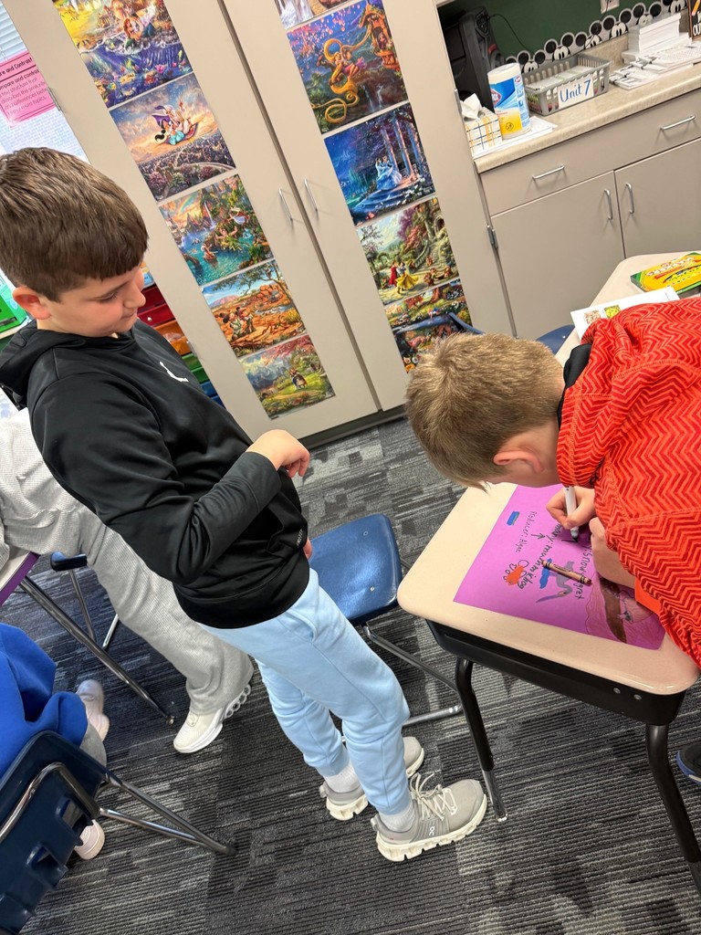 Students writing about ecosystems. 