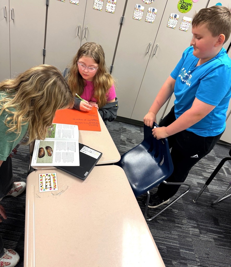 Students writing about ecosystems. 