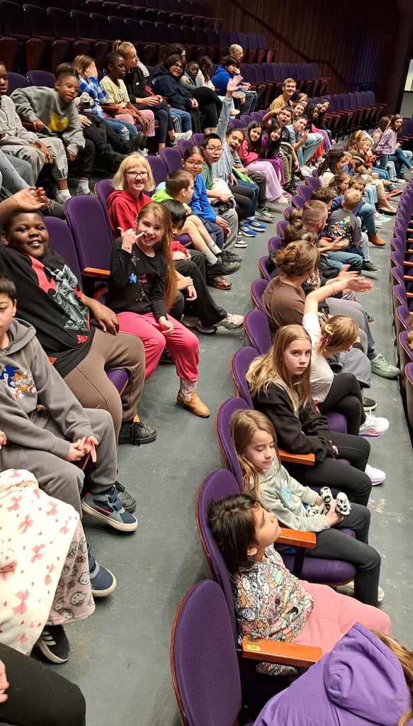 students and teachers in the theater