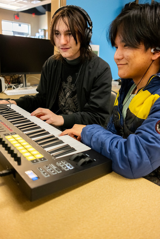 2 students working together on a music piece and recording