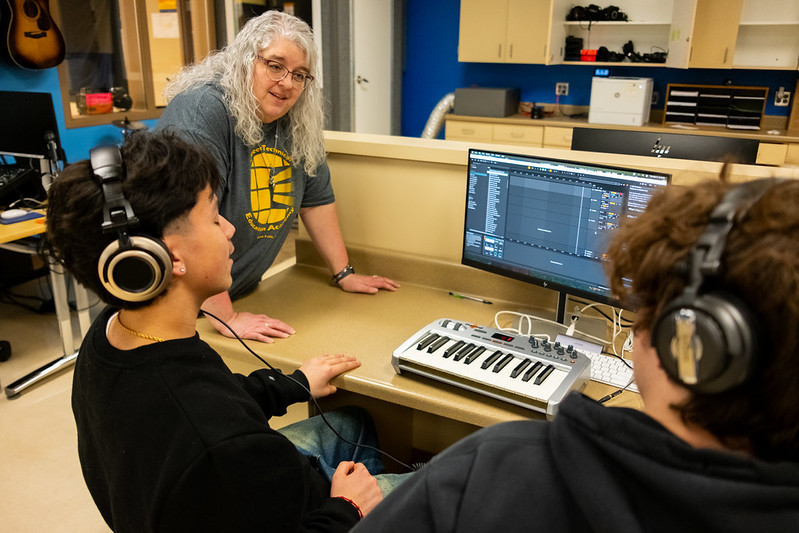 Mrs. Mehlert checking in on students music editing
