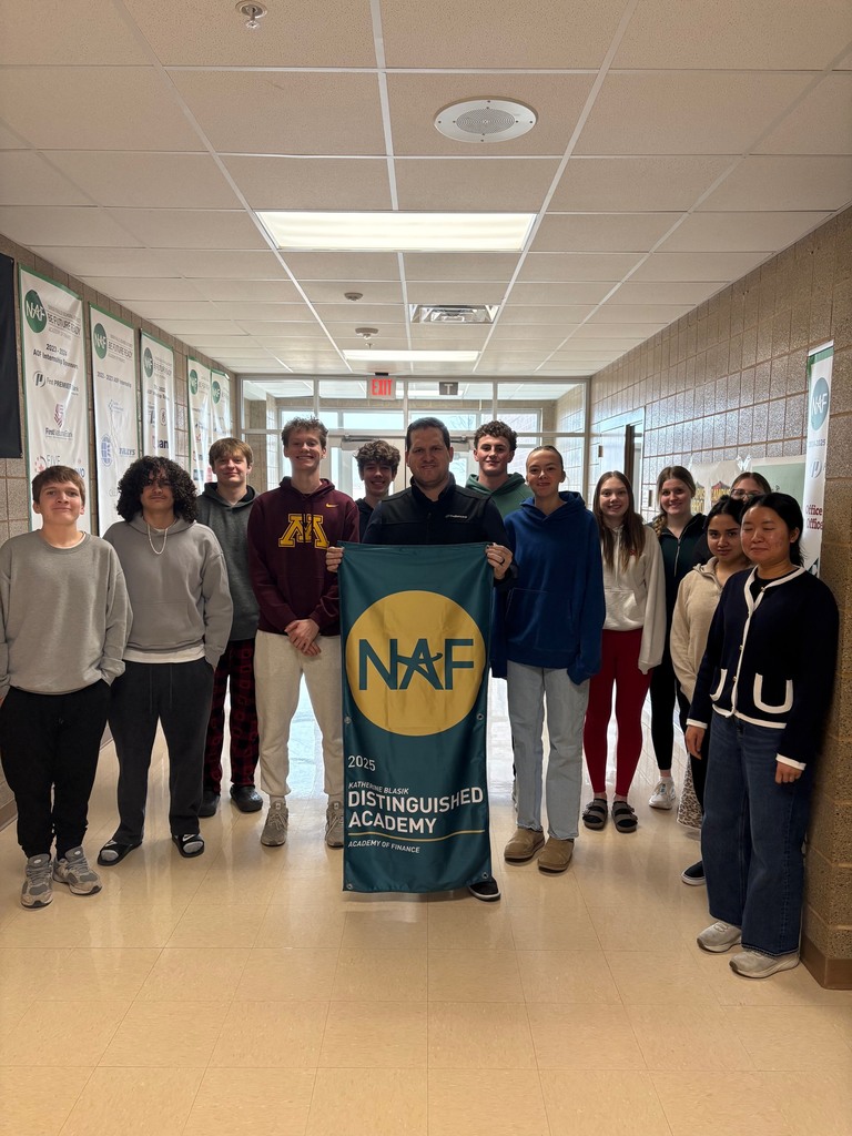 Academy of Finance with Guest speaker holding NAF sign