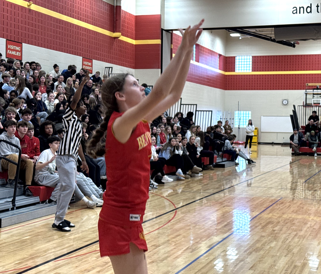 Bison student shoots and scores a basket at the staff vs student game.