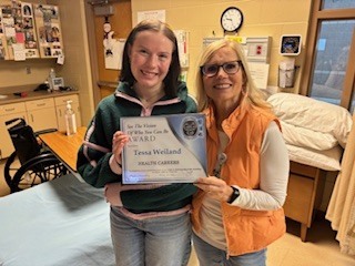 Mrs. Kennedy pictured with award student holding her award