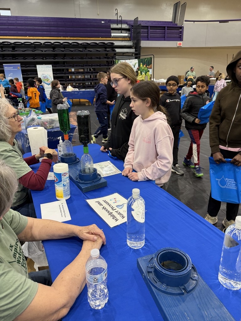 2 girls talking with staff