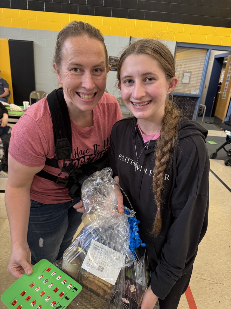 mom and daughter holding a prize basket