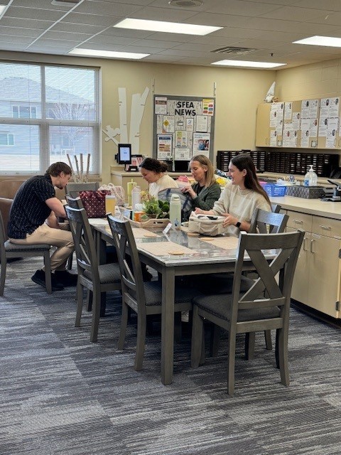 people eating lunch in the staff lounge
