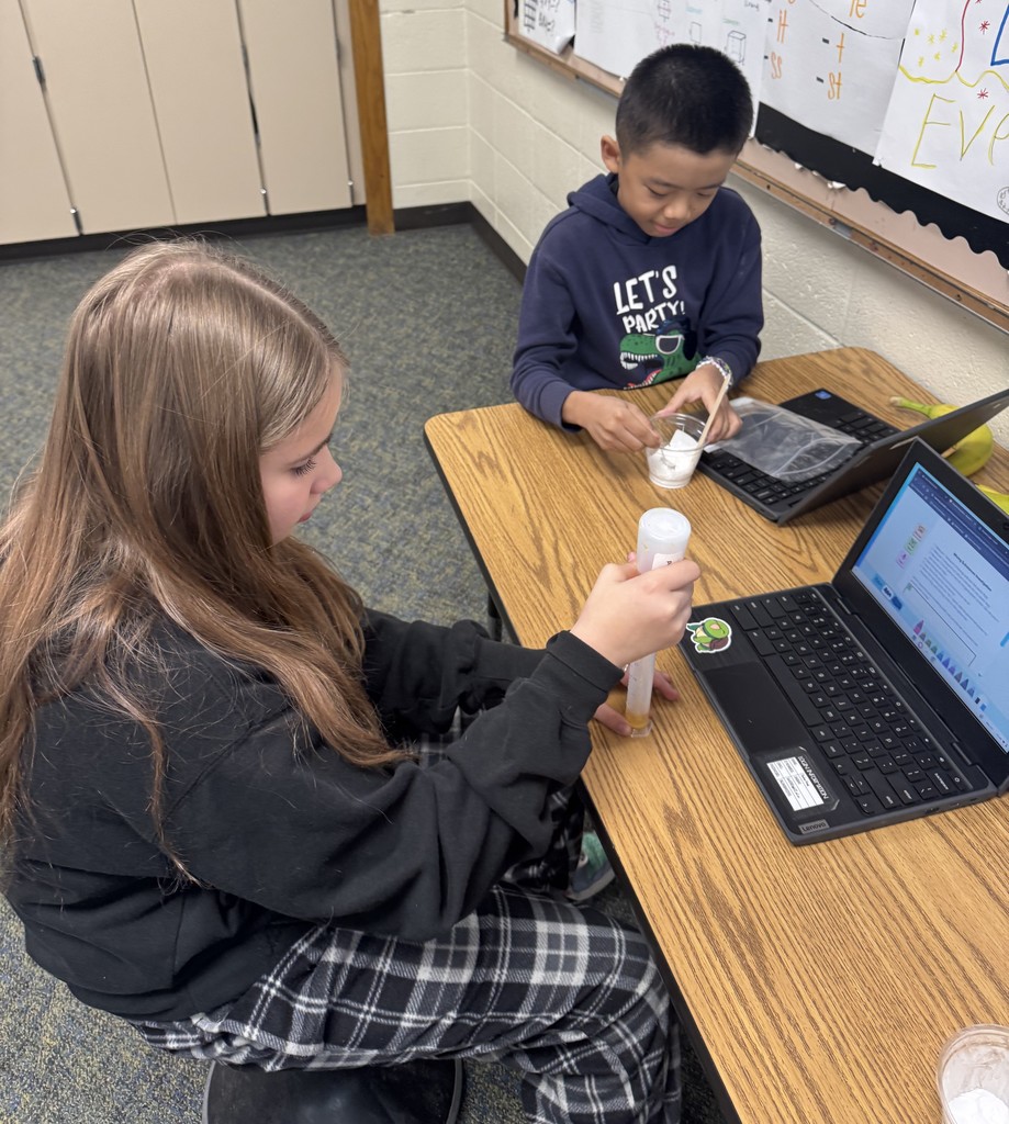 girl and boy doing science