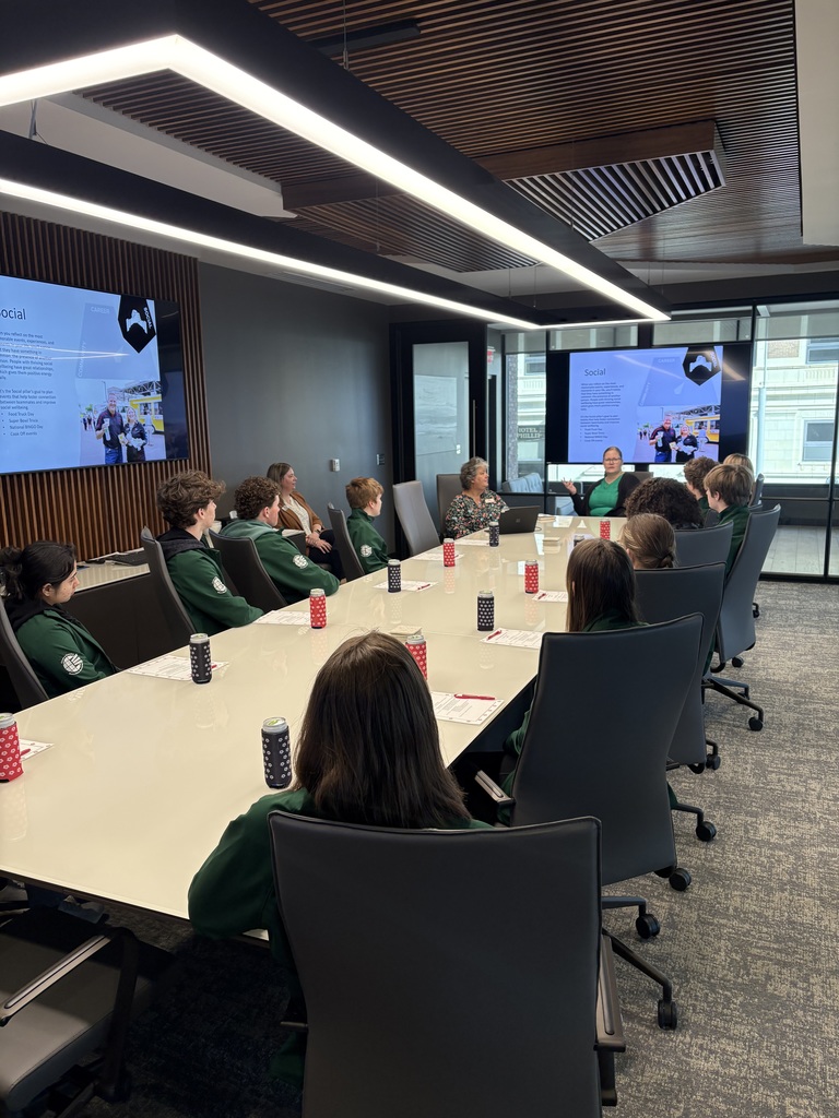 Academy of Finance with Guest speaker sitting at conference table