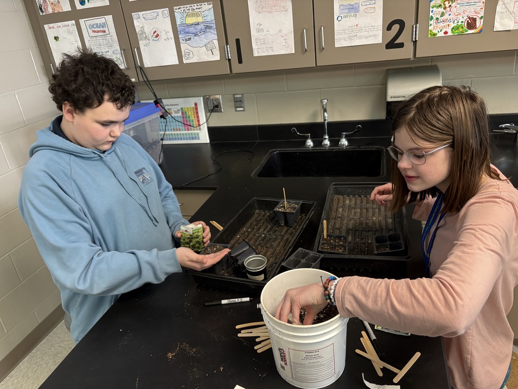 Garden club planting seeds. 