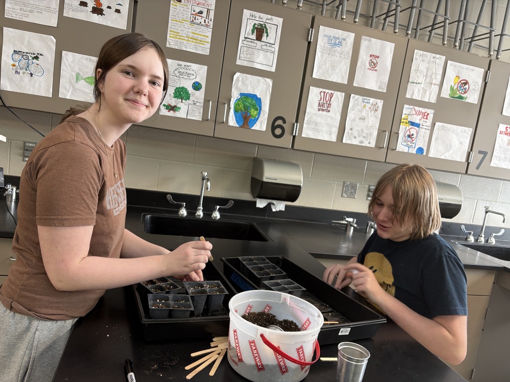 Garden club planting seeds. 
