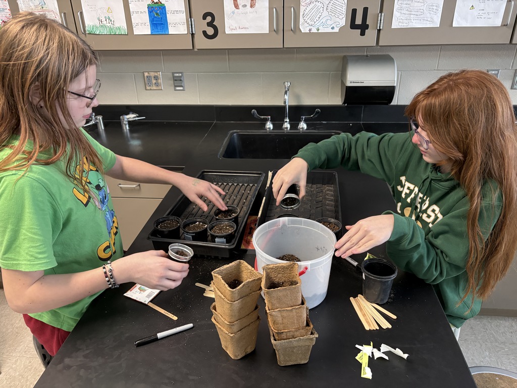 Garden club planting seeds. 