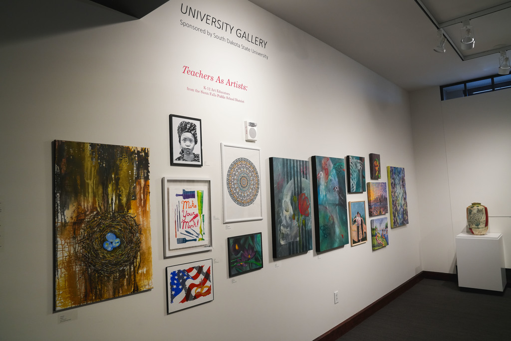 Art on a gallery wall. Title is "Teachers as artists".