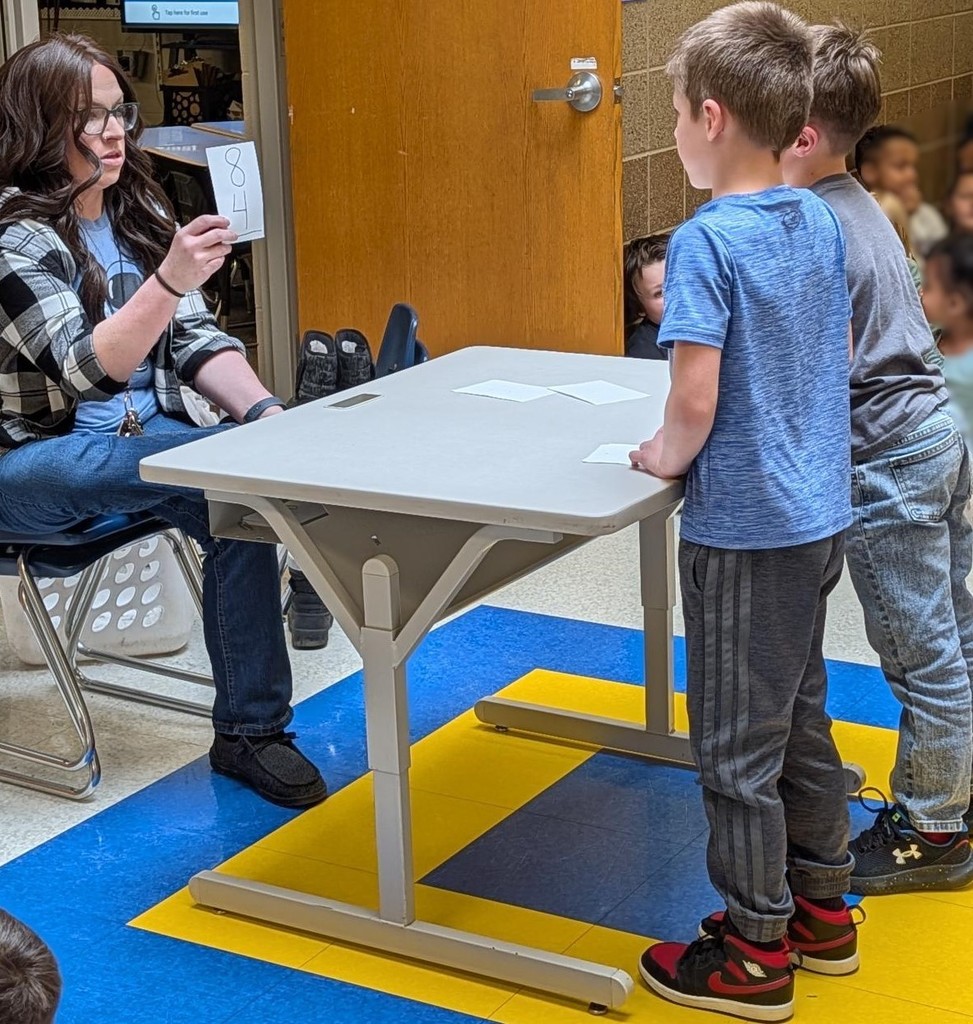 First grade boys doing math flash cards. 