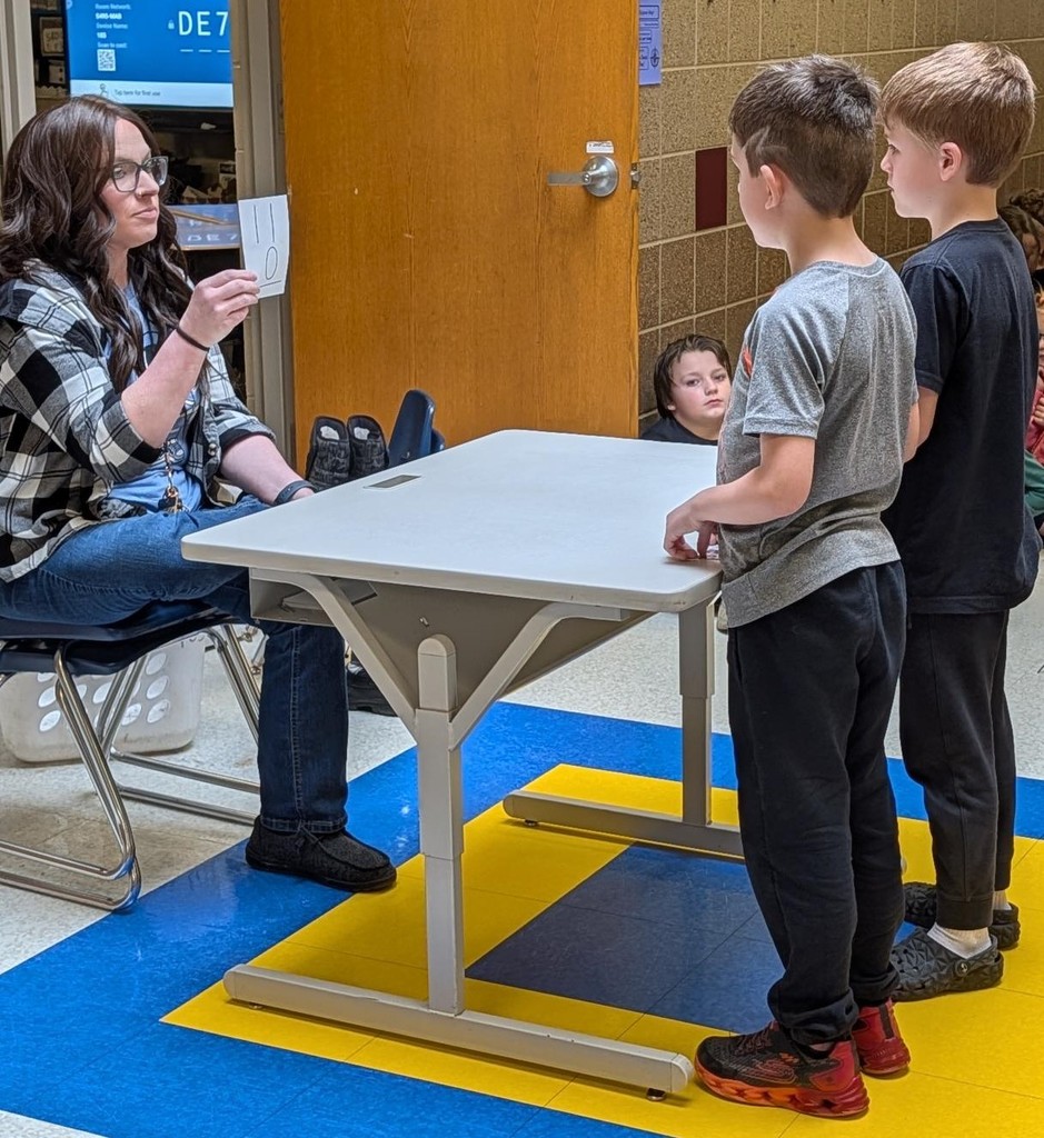 First grade boys doing math flash cards. 