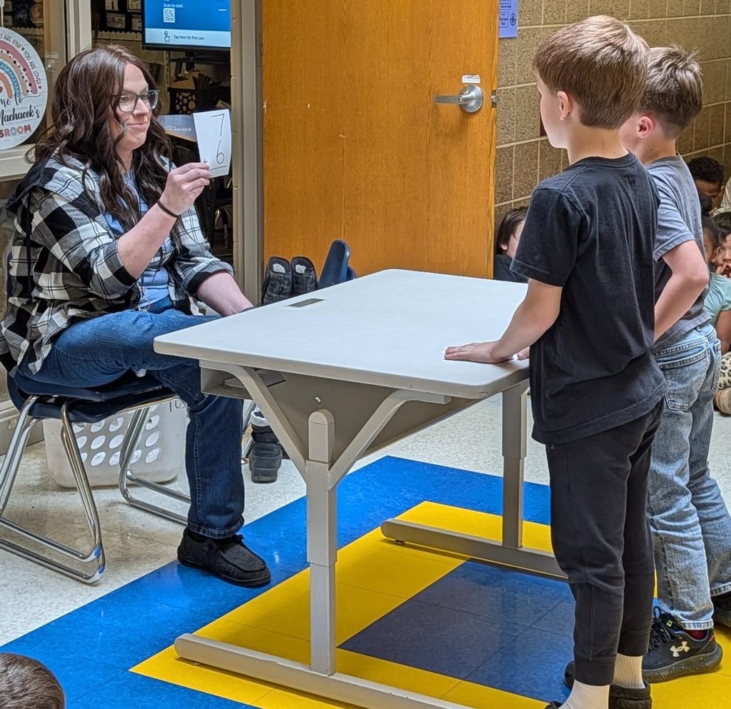 First grade boys doing math flash cards. 